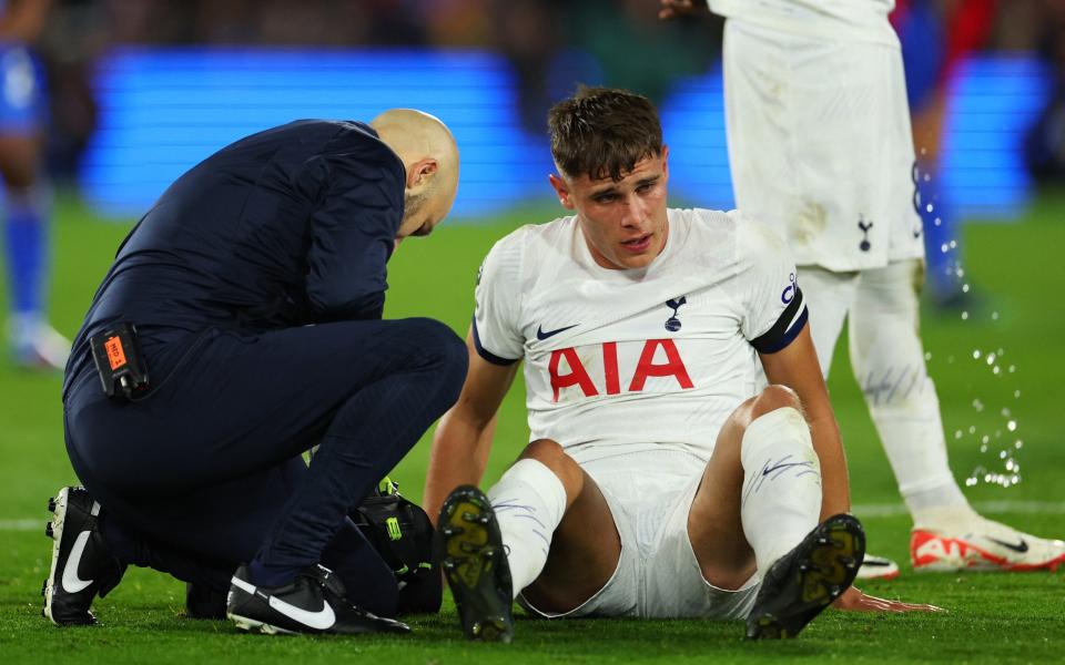 Tottenham Hotspur's Micky van de Ven receives medical attention