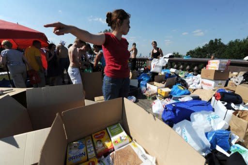 Russians pack boxes of donated clothing, food and household items at a humanitarian aid collection point in Moscow. Pro-government and opposition newspapers have showed rare unanimity in saying the authorities badly failed local inhabitants in the worst-hit town of Krymsk
