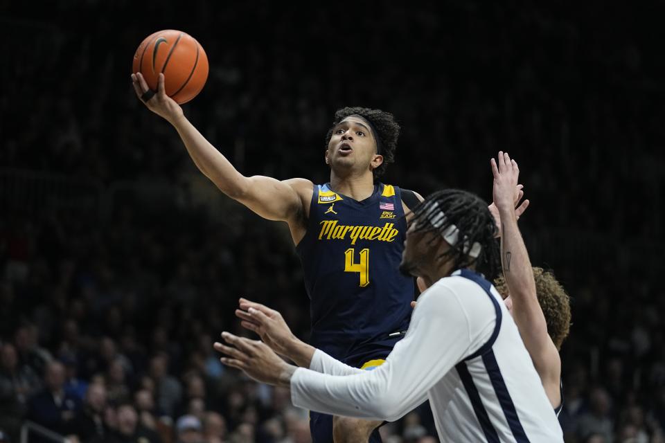 Marquette's Stevie Mitchell (4) shoots against Butler during the second half of an NCAA college basketball game Tuesday, Feb. 13, 2024, in Indianapolis. (AP Photo/Darron Cummings)