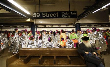 Performers in the 87th Macy's Thanksgiving Day Parade wait for a subway to take them to the start of the parade in New York November 28, 2013. REUTERS/Gary Hershorn