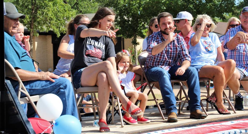 The family of Tom Carpenter, left, enjoyed the view from a flatbed. Carpenter, 90, was this year's grand marshal for the Hillcrest neighborhood parade.