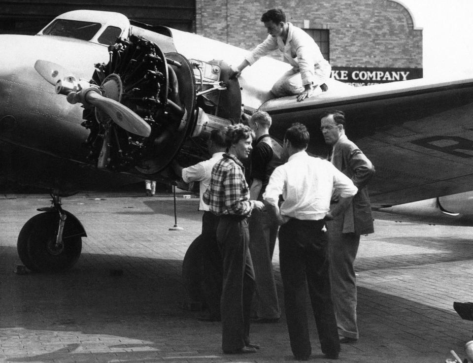 FILE - In this Sept. 4, 1936 file photo, Amelia Earhart is talking with her husband George Palmer Putnam, right, and friends in New York, before taking off from Brooklyn's Floyd Bennett field for Los Angeles in the Bendix Trophy race. Floyd Bennett Field was built between 1928 and 1931 and quickly became the preferred launching site for record-setting flights by Howard Hughes, Earhart, Wiley Post and other aviation pioneers. The Navy took over the airport in 1941 and most of the airport closed for good in 1971, but the New York Police Department still uses a corner of it as its helicopter base. (AP Photo, File)