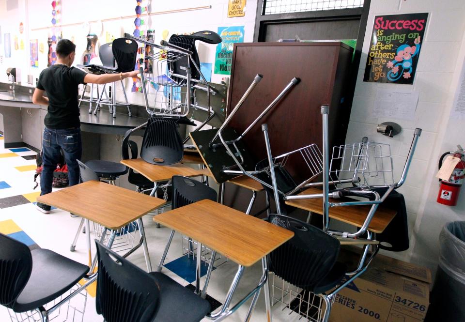 A student helps block the classroom door during a mock lockdown drill at Moody High School in Corpus Christi, Texas, in January 2013.