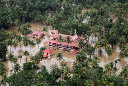 An aerial view shows partially submerged houses and church at a flooded area in Kerala, August 17, 2018. REUTERS/Sivaram V