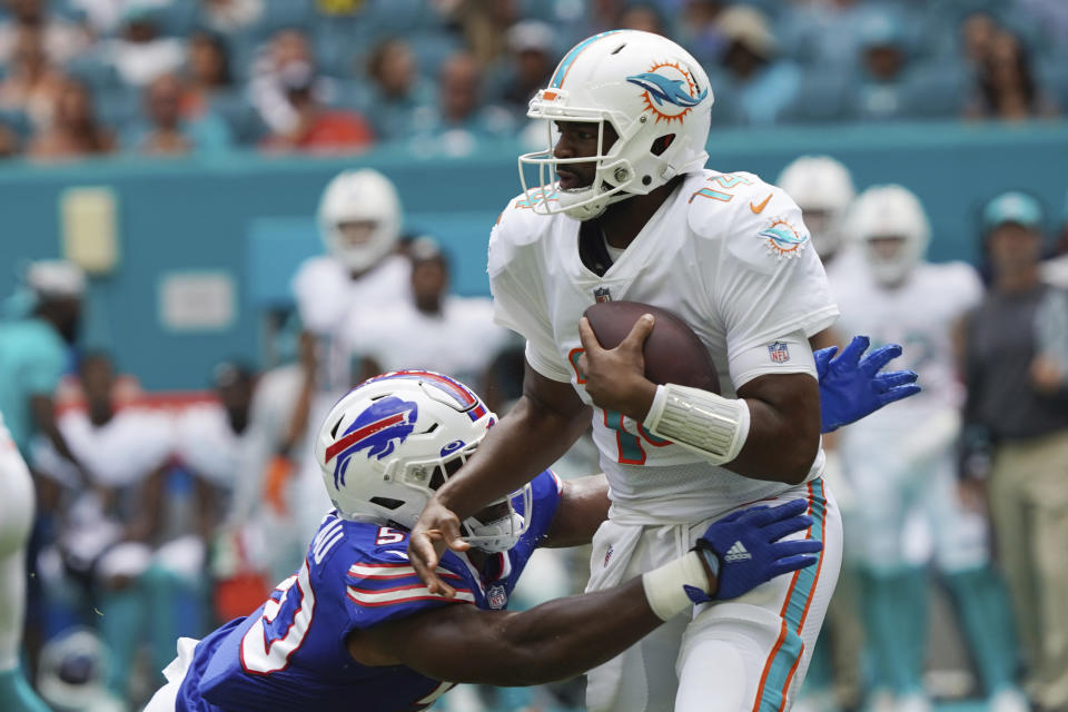 Buffalo Bills defensive end Greg Rousseau (50) pressures Miami Dolphins quarterback Jacoby Brissett (14), during the first half of an NFL football game, Sunday, Sept. 19, 2021, in Miami Gardens, Fla. (AP Photo/Hans Deryk)