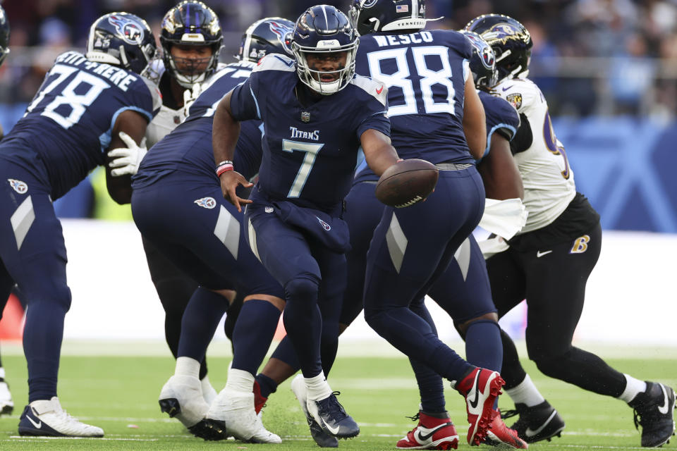 Tennessee Titans quarterback Malik Willis (7) looks to handoff the ball during the second half of an NFL football game against the Baltimore Ravens, Sunday, Oct. 15, 2023, at the Tottenham Hotspur stadium in London. (AP Photo/Ian Walton)