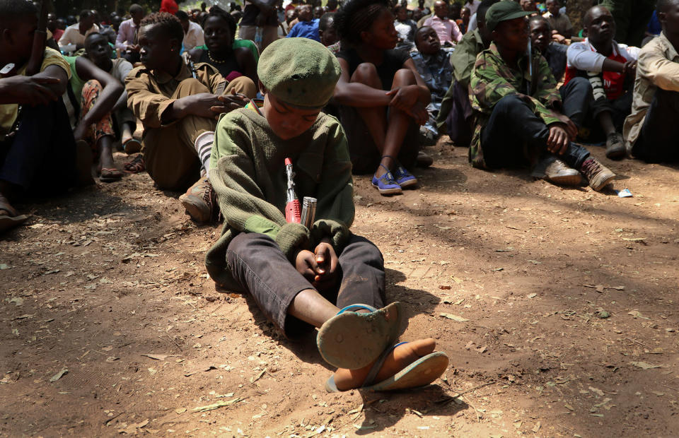 <p>A young child soldier sits on the ground at a release ceremony, where he and others laid down their weapons and traded in their uniforms to return to “normal life”, in Yambio, South Sudan Wednesday, Feb. 7, 2018. (Photo: Sam Mednick/AP) </p>