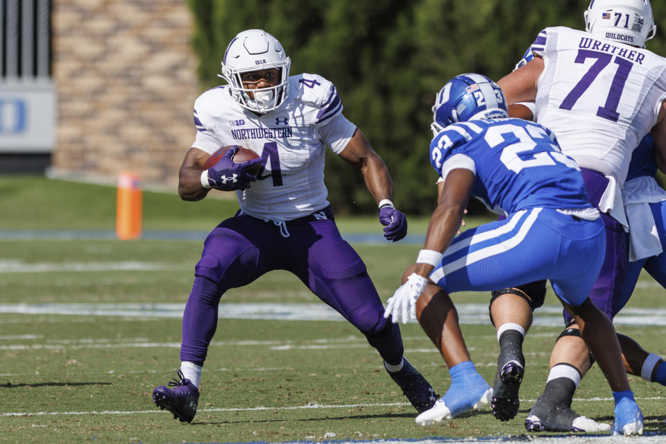 Northwestern's Cam Porter (4) carries the ball as Duke's Terry Moore (23) defends during the first half of an NCAA college football game in Durham, N.C., Saturday, Sept. 16, 2023. (AP Photo/Ben McKeown)