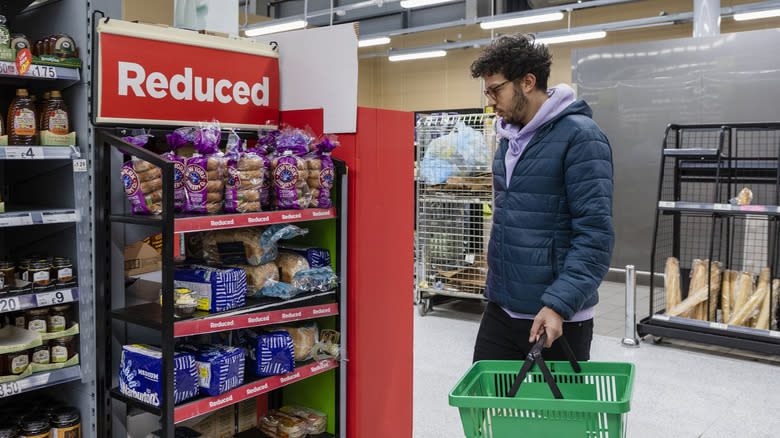 man looking at bread sale