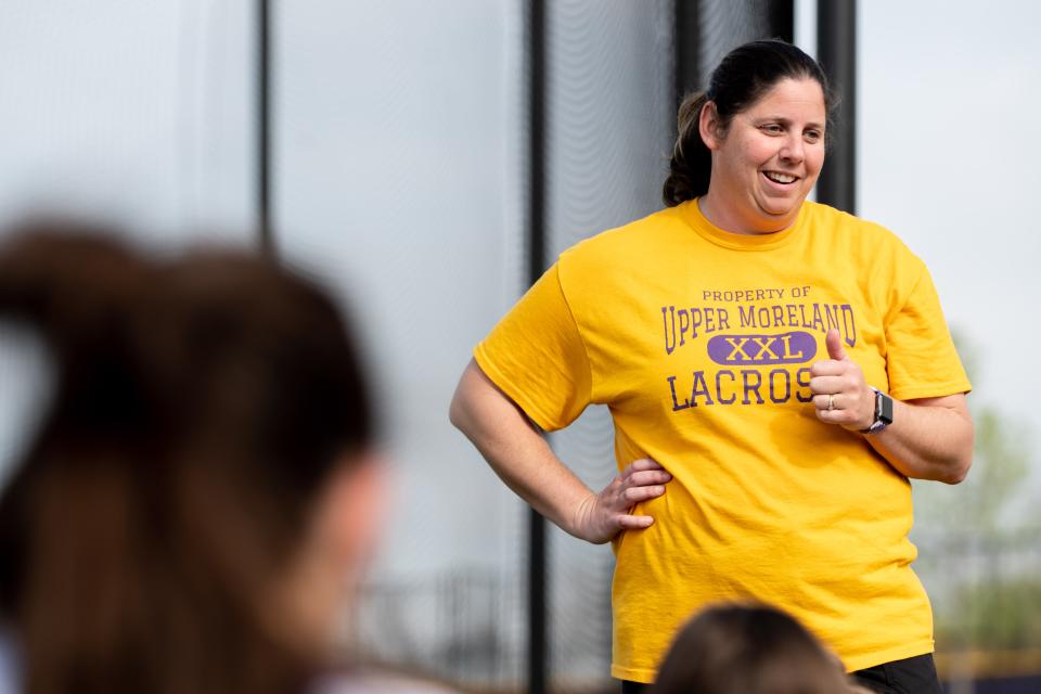 Upper Moreland's Kim Frantz praises her player during a post-game talk after a girls lacrosse game against Abington at Upper Moreland High School on Wednesday, May 4, 2022. The Golden Bears defeated the Ghosts 5-3.