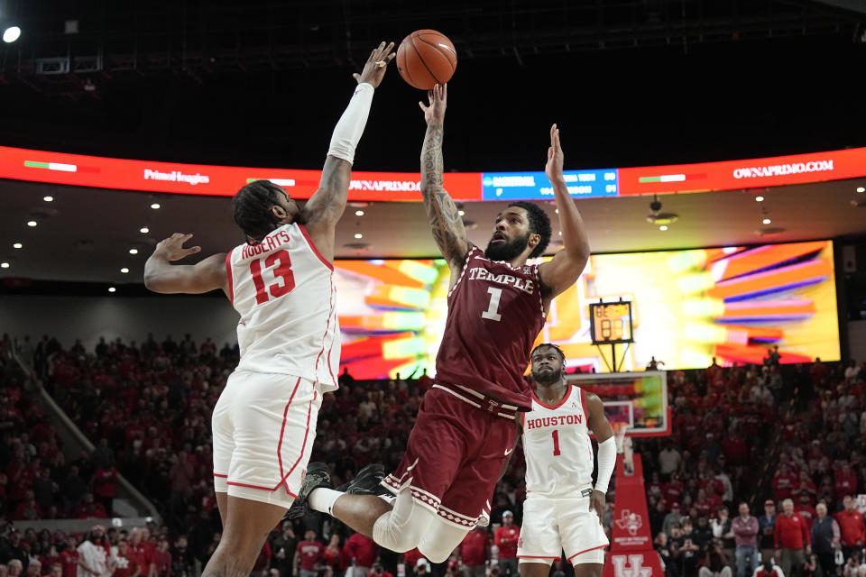 Temple's Damian Dunn (1) shoots as Houston's J'Wan Roberts (13) defends during the second half of an NCAA college basketball game Sunday, Jan. 22, 2023, in Houston. Temple won 56-55. (AP Photo/David J. Phillip)