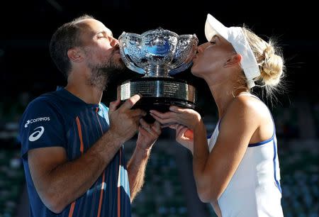 Russia's Elena Vesnina and Brazil's Bruno Soares kiss the mixed doubles trophy after winning their mixed doubles final match at the Australian Open tennis tournament at Melbourne Park, Australia, January 31, 2016. REUTERS/Issei Kato