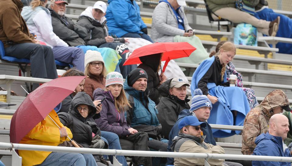 Fans watch action during Joe Sanford’s McDowell Track and Field Invitational at McDowell High School in Millcreek Township on Friday.