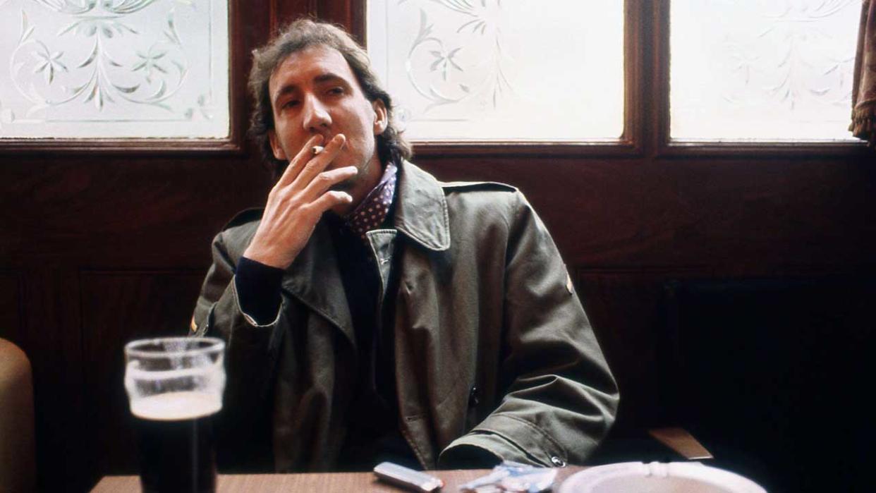  Pete Townshend smoking a cigarette in a pub. 