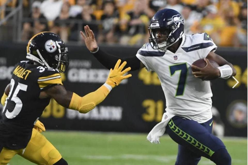 Seahawks quarterback Geno Smith runs around Steelers cornerback Arthur Maulet (35) on a scramble during the first half of Seattle’s first preseason game, Saturday night in Pittsburgh.