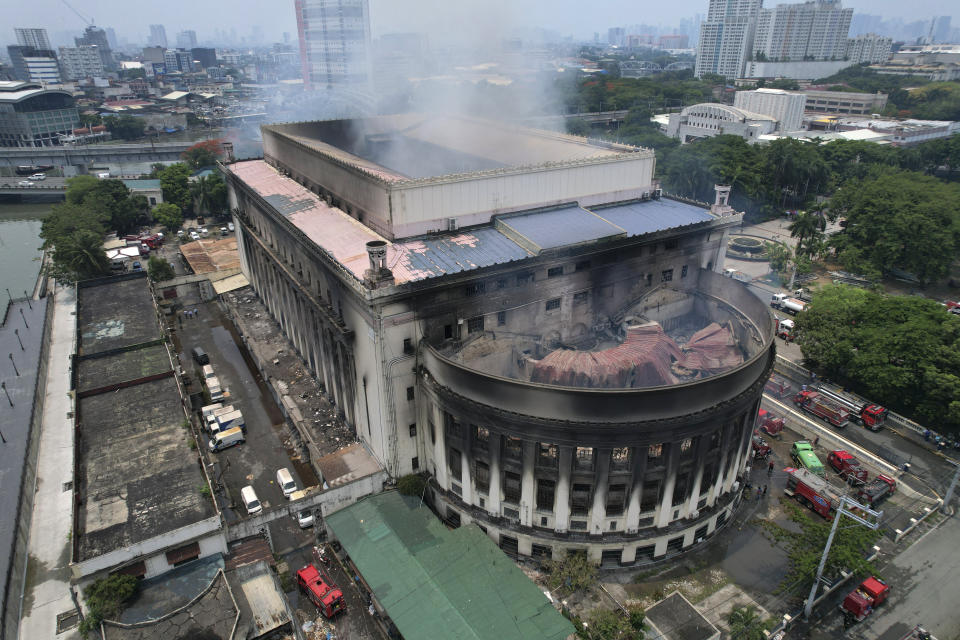 Smoke billows from the still smoldering Manila Central Post Office as a fire hits early Monday, May 22, 2023 in Manila, Philippines. A massive fire tore through Manila's historic post office building overnight, police and postal officials said Monday. (AP Photo/Aaron Favila)