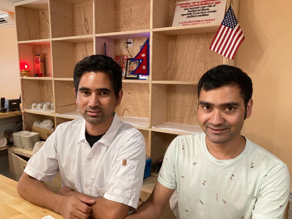 From left to right, Kabi and Raj Adhikari, brothers and co-owners of Laliguras Indian Nepali Restaurant, stand behind the counter at the Burlington business Aug. 3, 2022.