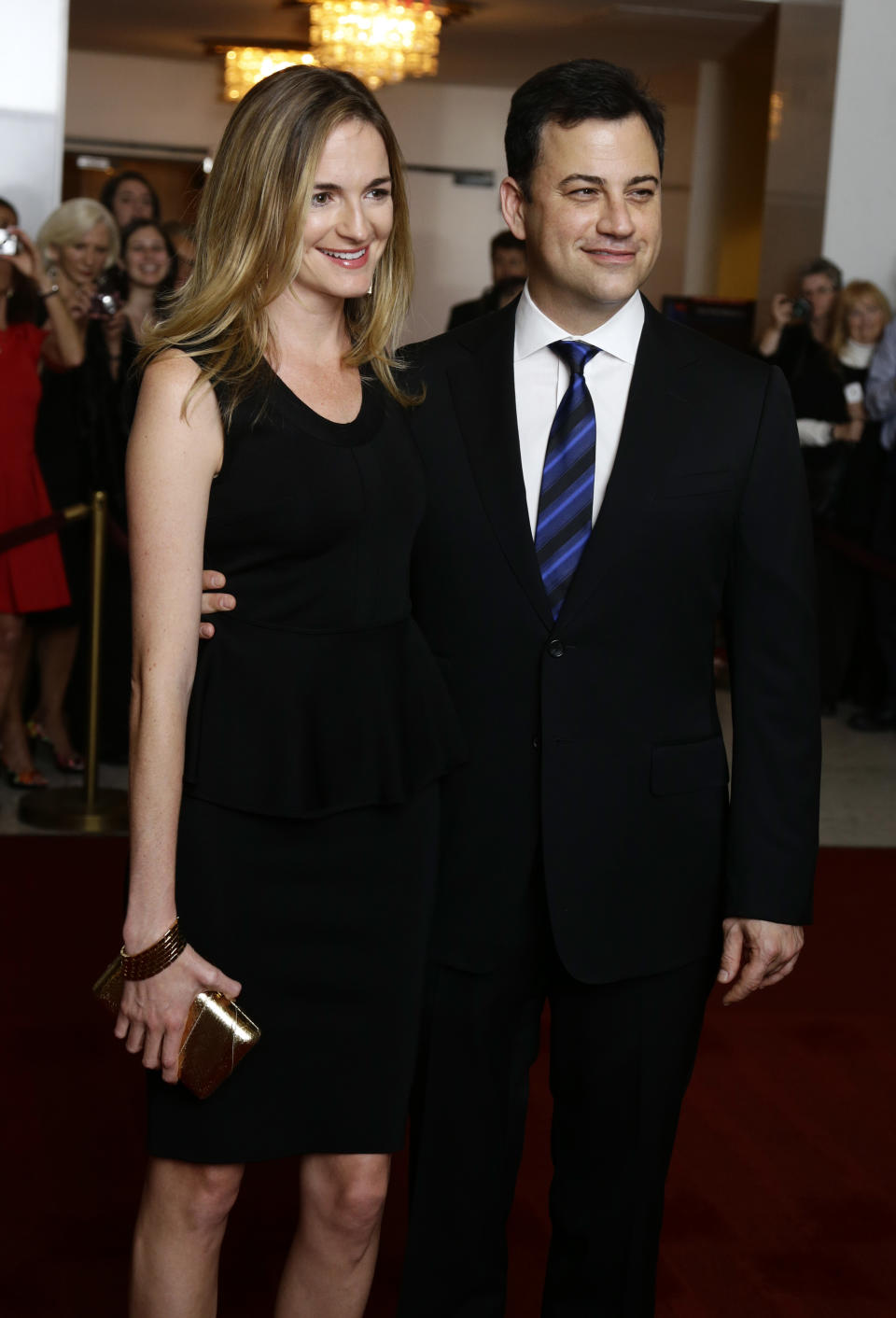 CORRECTS TO SAY McNEARY IS FIANCEE NOT WIFE - Entertainer Jimmy Kimmel, right, with his fiancee Molly McNearney, pose for photographers on the red carpet before entertainer Ellen DeGeneres receives the 15th annual Mark Twain Prize for American Humor at the Kennedy Center, Monday, Oct. 22, 2012, in Washington. (AP Photo/Alex Brandon)