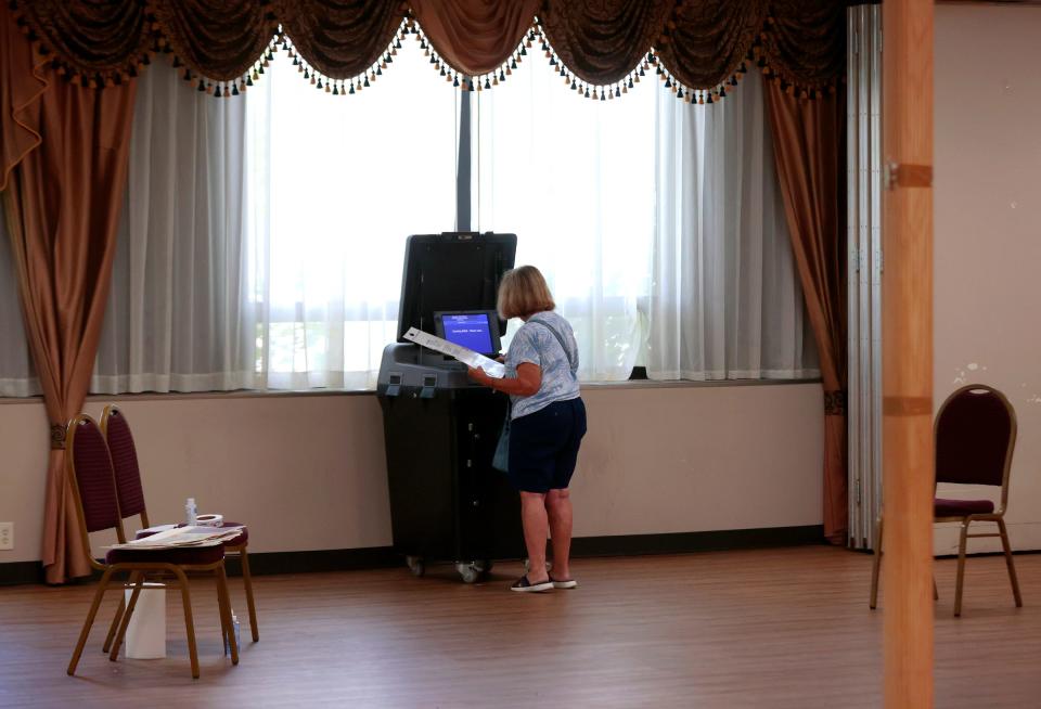 Gail Laabs, 71 of Warren puts her ballot into the voting tabulator at prescient 37 at Our Lady of Perpetual Help in Warren during the primary election on Tuesday, August 8, 2023. The city is holding elections for a new mayor.