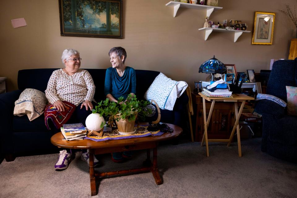 Becky Miller, left, and Marlene Mears, right, sit for a portrait in Miller’s living room in Longmont, Colo.