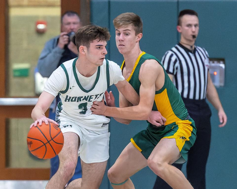 Williamston's Brooks Cline, who scored a team-high 22 points, looks to drive past Howell's Andrew Weber during the Hornets' 64-49 loss on Tuesday, Dec. 6, 2022.