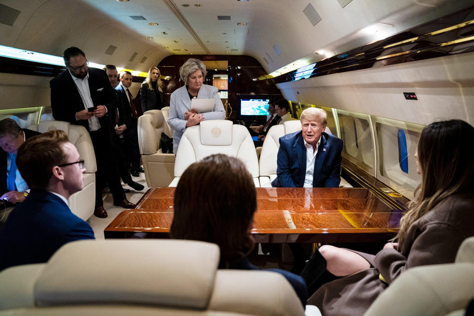 onald Trump speaks with Susie Wiles, center, staff and reporters while flying home on his airplane (Jabin Botsford / The Washington Post via Getty Images file)