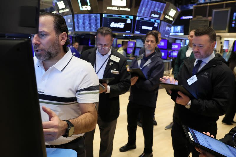 Traders work on the floor of the NYSE in New York