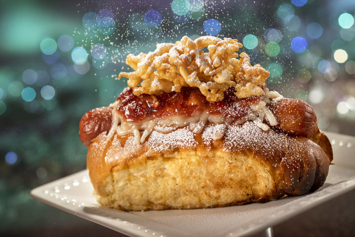 Casey's Corner, located inside Magic Kingdom Park, is serving up this 50th Celebration Hot Dog, topped with funnel cake, powdered sugar and strawberry bacon jam. (Photo: Walt Disney World Resort)