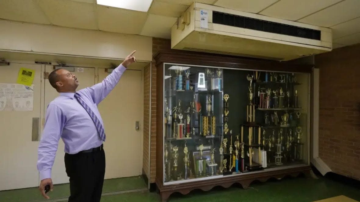 Jim Hill High School Principal Bobby Brown points out one of the outdated air-condition units that are installed throughout the Jackson, Mississippi school. A litany of infrastructure issues in the nearly 60-year-old school make for tough choices on spending COVID recovery funds on infrastructure or academics. (Photo: Rogelio V. Solis/AP)