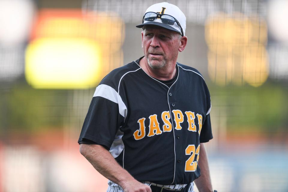 Jasper Head Coach Terry Gobert walks back to the dugout while his team competes in the IHSAA Class 4A sectional championship against the Central Bears at Bosse Field in Evansville, Ind., Monday, May 31, 2021. The Wildcats defeated the Bears 10-0 to win the 4A sectional title. 