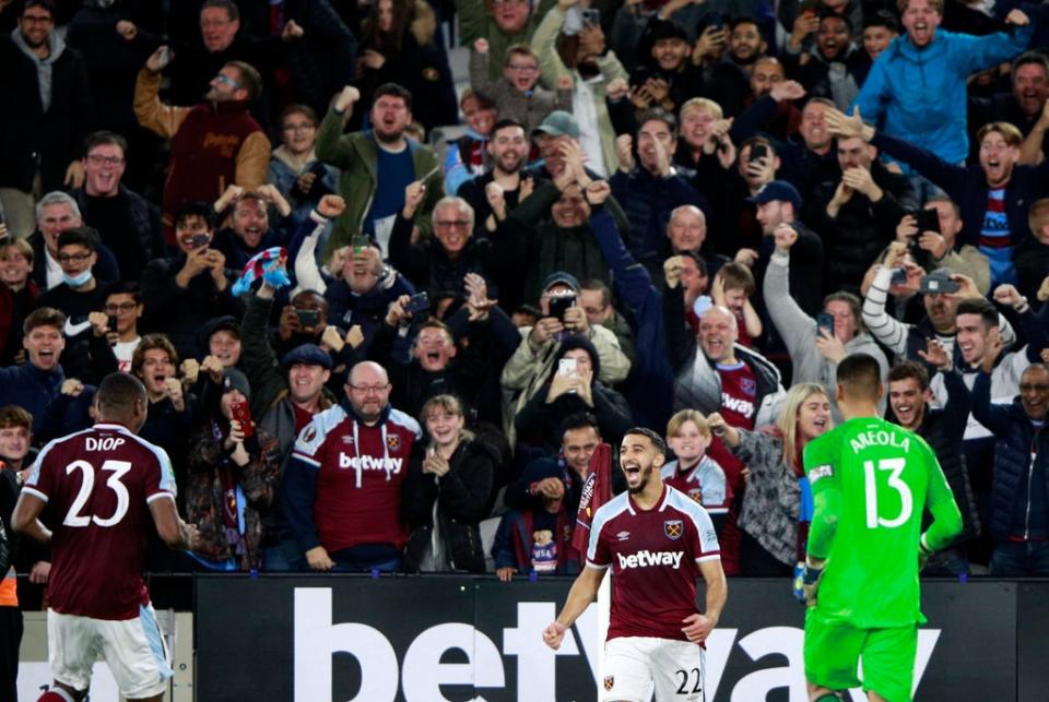 Said Benrahma celebrates his winning spot-kick, and the Hammers fans join in (AP)