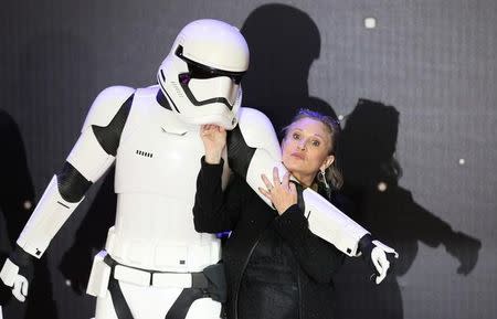 Carrie Fisher poses for cameras as she arrives at the European Premiere of Star Wars, The Force Awakens in Leicester Square, London, December 16, 2015. REUTERS/Paul Hackett/Files