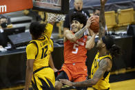 Illinois' Andre Curbelo, center, shoots between Missouri's Dru Smith, left, and Mitchell Smith, right, during the first half of an NCAA college basketball game Saturday, Dec. 12, 2020, in Columbia, Mo. (AP Photo/L.G. Patterson)