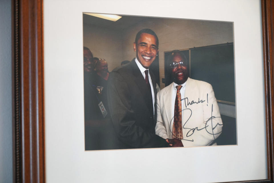 A photograph of the late William Penn Troy Sr. with former President Barack Obama hangs on the wall of Troy's office in Mullins, S.C., on Sunday, May 23, 2021. Over the years, Troy, a funeral director, had served as a county commissioner, local school board member and church treasurer. But those were just his official duties. (AP Photo/Allen G. Breed)