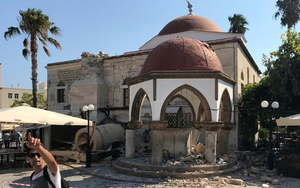 the toppled minaret of a mosque  - Credit: Michael Probst/AP