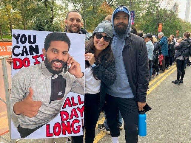Denise Rodriguez holds up a sign cheering on her friend, a Bergen County detective, on Sunday, Nov. 5 at the New York City Marathon