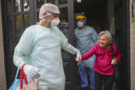 FILE - In this April 22, 2020 file photo, medical staff evacuate an elderly woman from a nursing home after multiple residents of the facility tested positive for the COVID-19 coronavirus in Buenos Aires, Argentina. Argentina reached 1 million confirmed coronavirus cases on Monday, Oct. 19, 2020, according to the Ministry of Health. (AP Photo/Natacha Pisarenko, File)