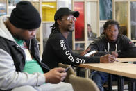 E. Matthis, center, an outreach specialist with Memphis Allies, takes part in a meeting to discuss information on recent area shootings Oct. 24, 2022, in Memphis, Tenn. At left is Bryan Mathis and at right is Eric Hammond. (AP Photo/Mark Humphrey)