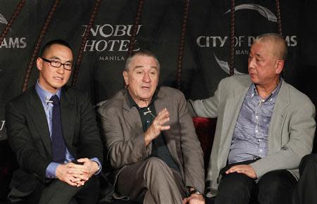 Actor Robert De Niro (C) gestures between Lawrence Ho (L), Co-chairman and Chief Executive Officer of Melco Crown Entertainment Limited, and celebrity chef Nobuyuki "Nobu" Matsuhisa during a news conference in Manila January 27, 2014. REUTERS/Romeo Ranoco