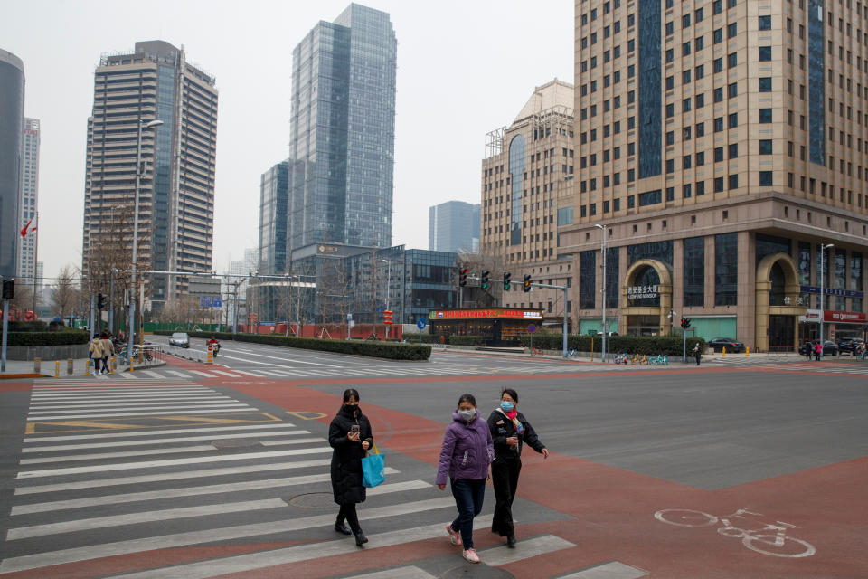 People cross an empty street in the Central Business District in Beijing as the country is hit by an outbreak of the novel coronavirus. Source: Reuters/Thomas Peter