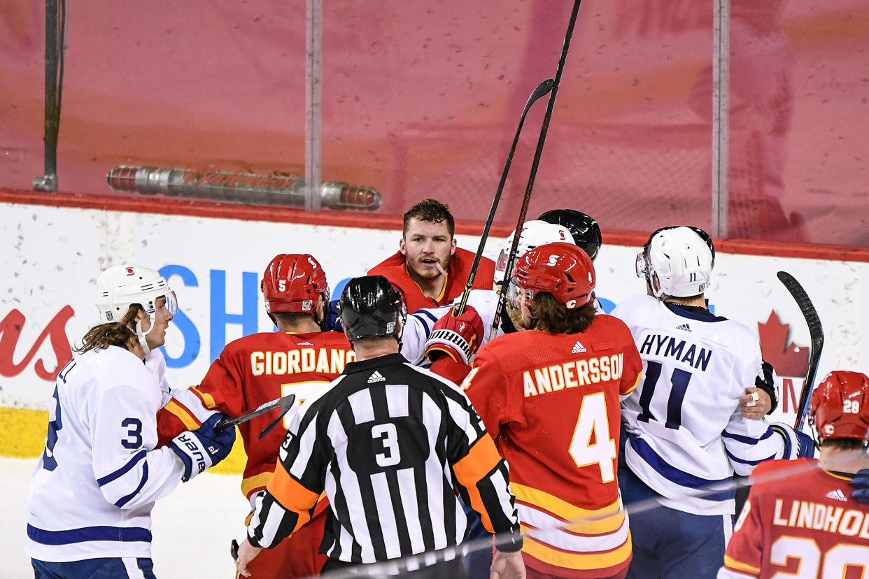 CALGARY, AB - JANUARY 26: Calgary Flames Left Wing Matthew Tkachuk (19) and Toronto Maple Leafs Defenceman Jake Muzzin (8) mix it up after the final buzzer after the Toronto Maple Leafs beat the Calgary Flames 4-3 in an NHL game where the Calgary Flames hosted the Toronto Maple Leafs on January 26, 2021, at the Scotiabank Saddledome in Calgary, AB. (Photo by Brett Holmes/Icon Sportswire via Getty Images)