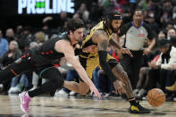 Toronto Raptors guard Gary Trent Jr., right, steals the ball from Washington Wizards forward Deni Avdija (8) during the first half of an NBA basketball game in Toronto Sunday, April 7, 2024. (Frank Gunn/The Canadian Press via AP)