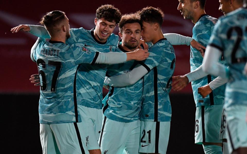 Xherdan Shaqiri of Liverpool celebrates with teammates after scoring his team's first goal during the Carabao Cup third round match between Lincoln City and Liverpool at Sincil Bank Stadium on September 24, 2020 in Lincoln, England.  - GETTY IMAGES