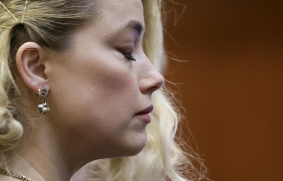 Actor Amber Heard waits before the verdict was read at the Fairfax County Circuit Courthouse in Fairfax, Va, Wednesday, June 1, 2022. The jury awarded Johnny Depp more than $10 million in his libel lawsuit against ex-wife Amber Heard. It vindicates his stance that Heard fabricated claims that she was abused by Depp before and during their brief marriage. But the jury also found in favor of Heard, who said she was defamed by a lawyer for Depp.(Evelyn Hockstein/Pool via AP)