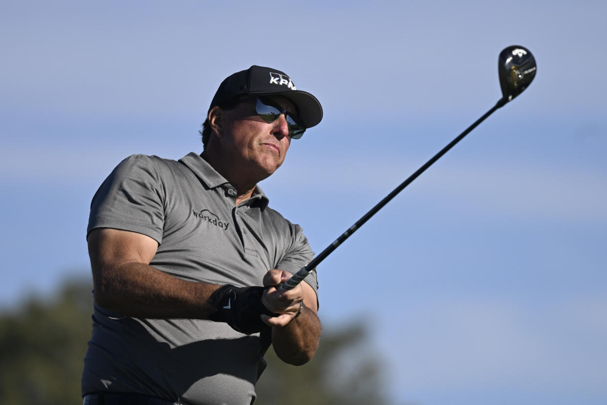 FILE - Phil Mickelson hits his tee shot on the fifth hole of the South Course at Torrey Pines during the first round of the Farmers Insurance Open golf tournament, Jan. 26, 2022, in San Diego. Phil Mickelson, the chief recruiter for a Saudi-funded rival league to the PGA Tour, was the last big name to join the 48-man field for the LIV Golf Invitational that starts Friday outside London. It will be Mickelson's first time playing since Feb. 6 at the Saudi International. (AP Photo/Denis Poroy, File)