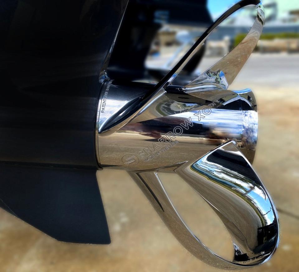 shiny steel propeller with loops for blades on the back of a ship