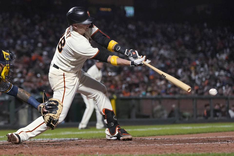 San Francisco Giants' Buster Posey hits an RBI single against the Milwaukee Brewers during the fifth inning of a baseball game in San Francisco, Wednesday, Sept. 1, 2021. (AP Photo/Jeff Chiu)