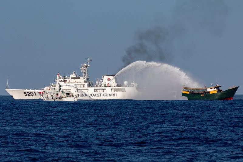 FILE PHOTO: Chinese Coast Guard vessels fire water cannons towards a Philippine resupply vessel Unaizah May 4 on its way to a resupply mission at Second Thomas Shoal in the South China Sea