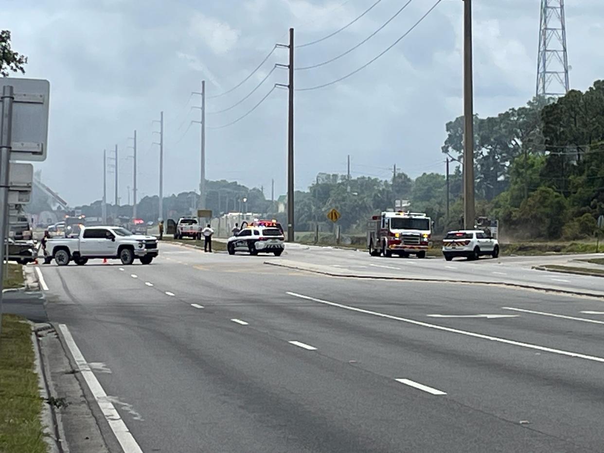 Fire officials block Babcock Street at Agora Circle in Palm Bay on Sunday afternoon as a 20-acre brush fire burned near the road.