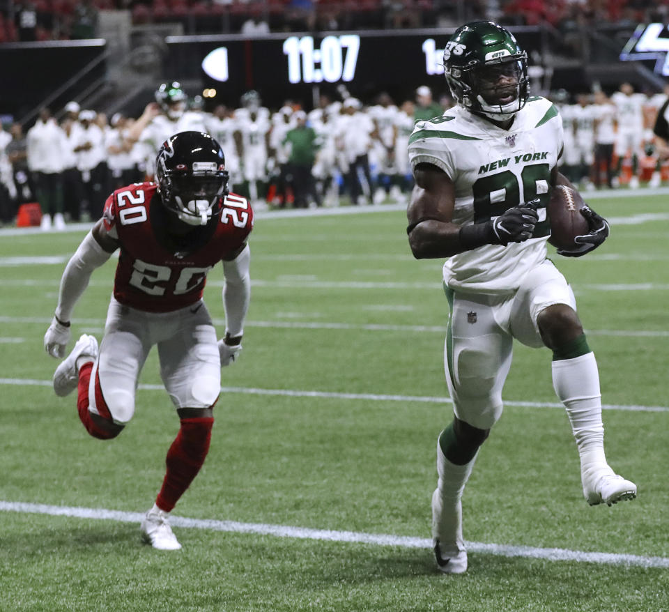 New York Jets running back Ty Montgomery gets past Atlanta Falcons defensive back Kendall Sheffield for a touchdown during the first half of an NFL football preseason game Thursday, Aug. 15, 2019, in Atlanta. (Curtis Compton/Atlanta Journal Constitution via AP)